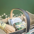 Seed collecting kit with materials in a basket against a green background