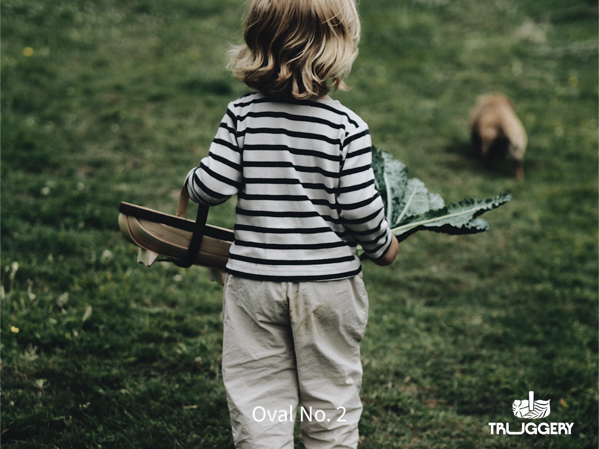 Child holding authentic Oval No.2 trug in the countryside