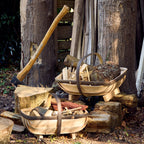 Wooden trugs and tools on the ground in a rustic setting